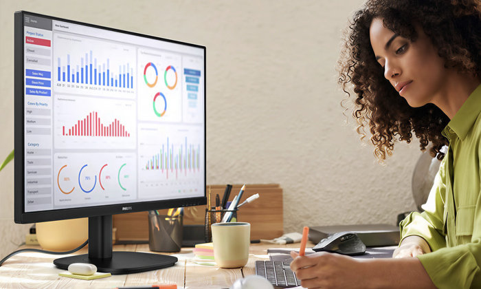 A woman is working with the tco edge certified Philips Monitors