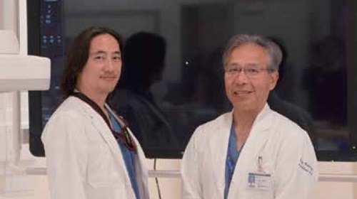 Two doctors smiling and looking at the viewer